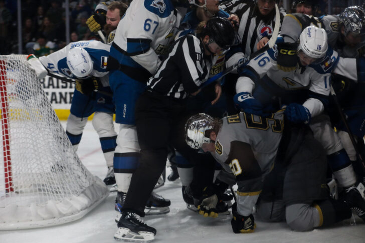 A scrum behind the net. 